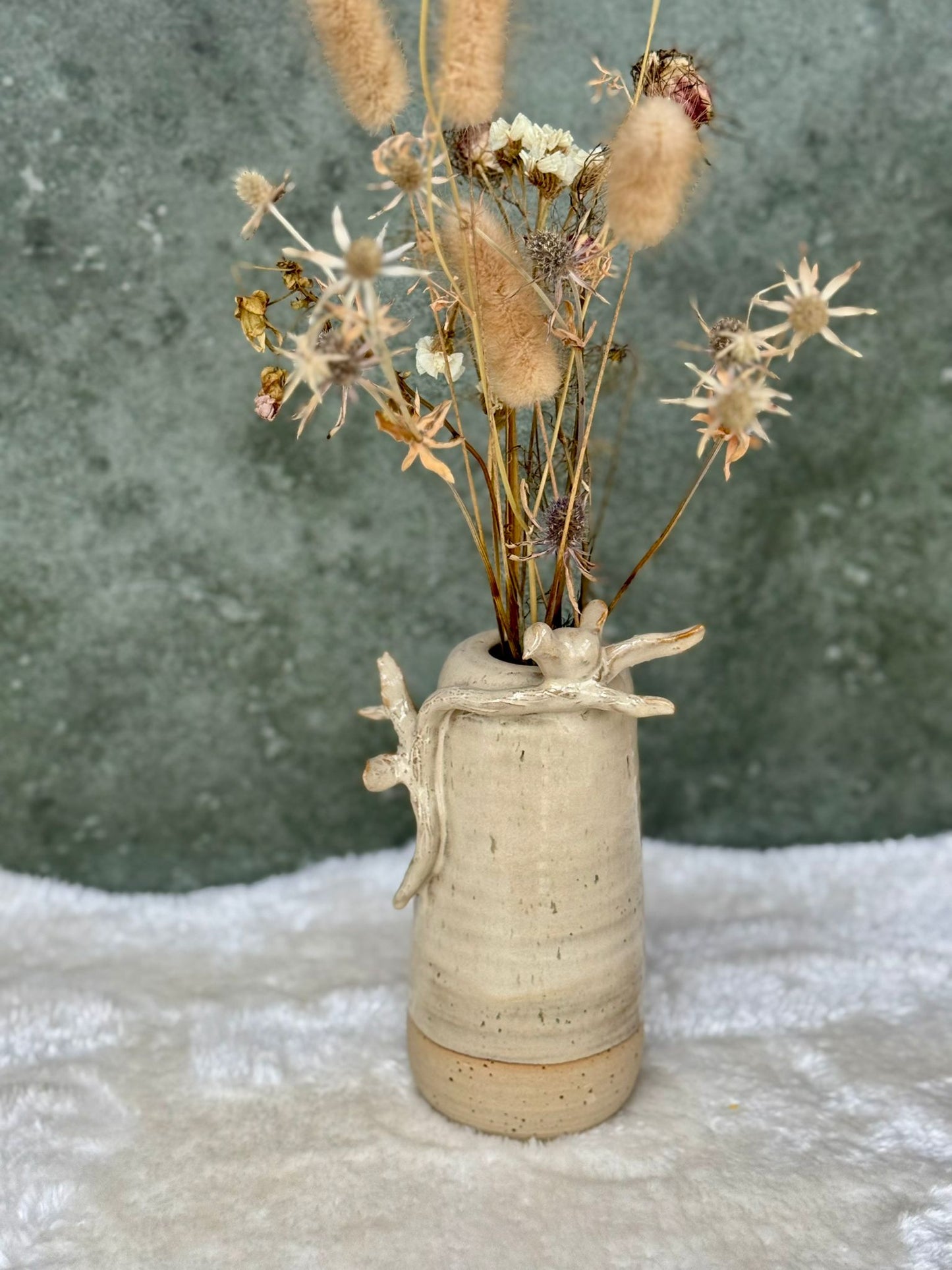 Vaas met rustend vogeltje op een takje